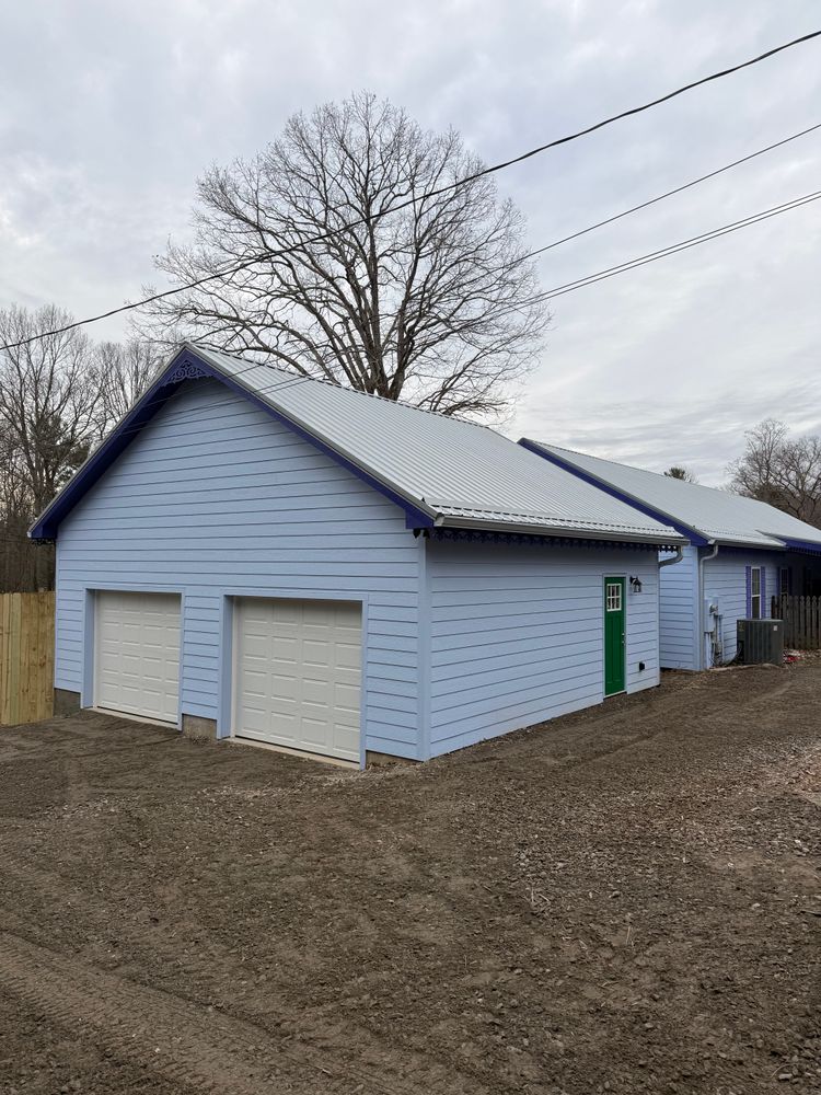 Enhance your home with our Garages and Expansions service, expertly crafting seamless deck and patio extensions that blend functionality with beauty, tailored to fit your lifestyle and outdoor living aspirations. for Karnezis Construction in Candler, NC