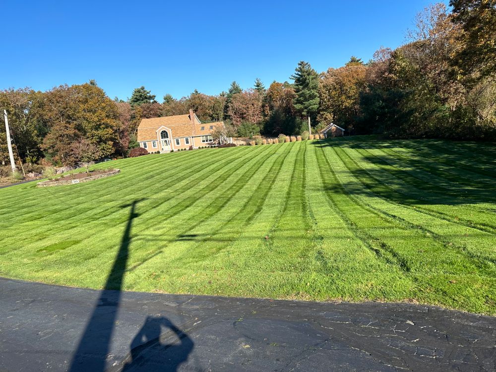 Our professional mowing service ensures your lawn will be kept neatly trimmed and looking its best all season long, providing you with more free time to enjoy your outdoor space. for Garduno Landscaping LLC in Cumberland, RI