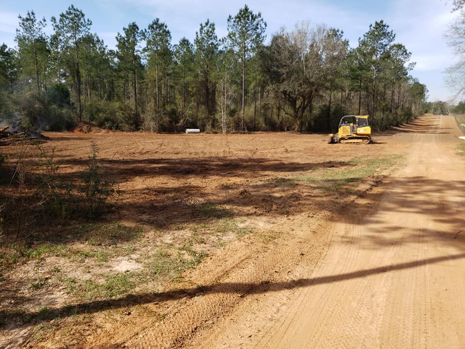 Our Dirt Work service expertly manages land clearing, grading, and excavation to create a solid foundation for your outdoor projects. Enhance your property's landscape with precision and care tailored to homeowners' needs. for Coldwater Creek Enterprises in Pace, FL