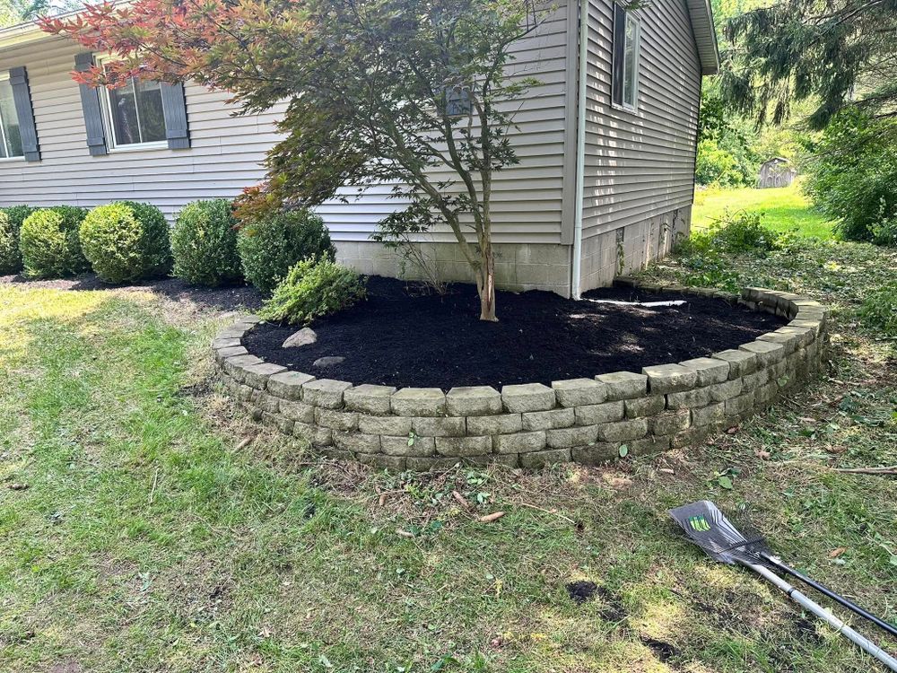 Our Retaining Wall Construction service enhances your property's aesthetics and functionality, providing durable structures to prevent soil erosion while seamlessly blending with your landscape for a beautiful, lasting outdoor solution. for Sargent's Lawn and Property Maintenance LLC in Lambertville, MI