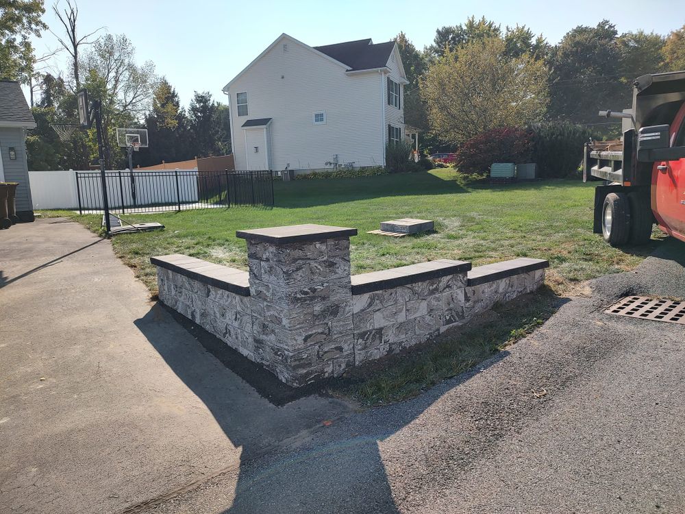 Our Retaining Wall Construction service provides expert design and installation of durable walls that enhance the functionality and aesthetics of your outdoor space, ensuring proper soil retention for long-lasting results. for J&F Lawn and Yard Care  in Burnt Hills, NY