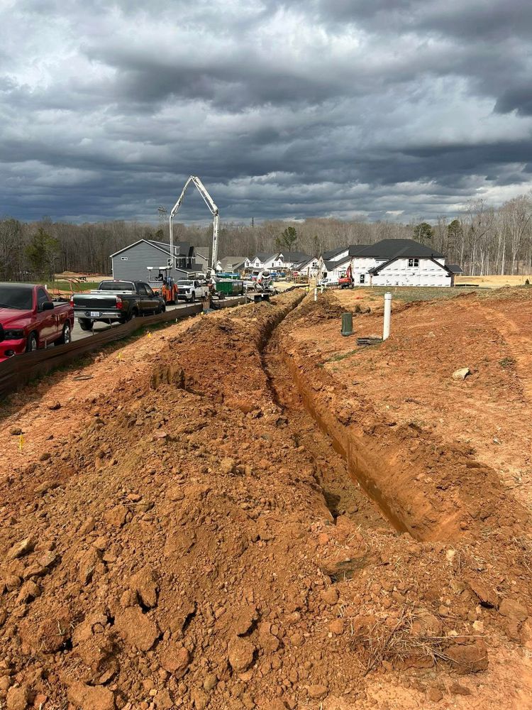 Our drainage systems service installs and improves underground solutions that move water away from your home, helping prevent flooding, foundation damage, yard erosion, and costly moisture problems through expert trenching. for Dynamic Trench Solutions LLC in Harmony, NC