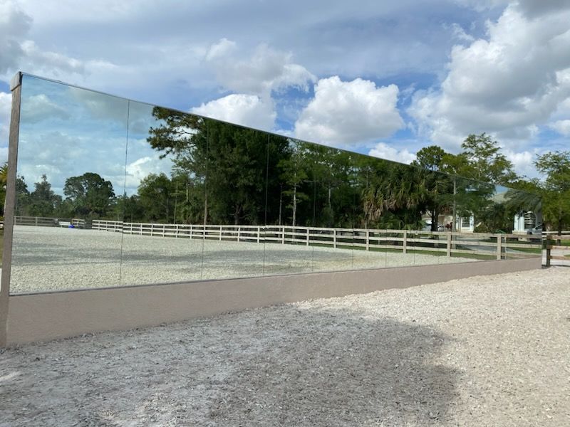 Elevate your equestrian space with our wooden or concrete mirror walls, designed to combine durability and sophistication. Enhance visibility, improve safety, and add a touch of elegance to your arena, creating the perfect environment for optimal riding performance. for Florida Native Equestrian Services in Central Florida, FL