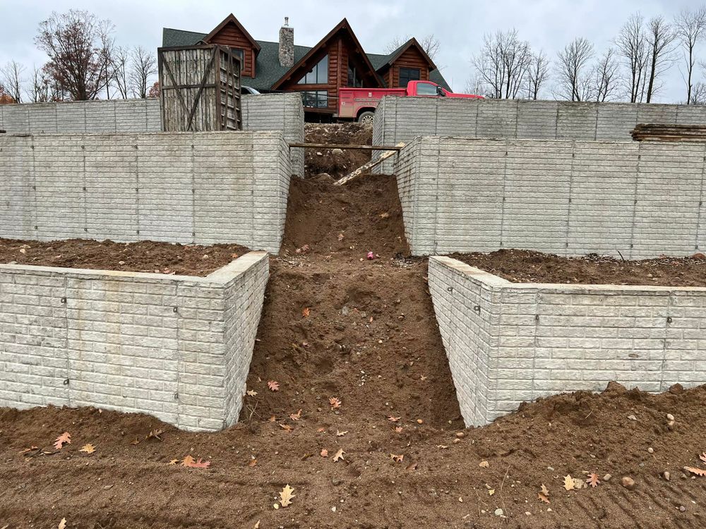 Our retaining wall construction service provides durable, aesthetically pleasing solutions to stabilize slopes and prevent erosion, tailored specifically for your property’s landscape needs using top-quality concrete materials. for Johnsons Custom Creations in Milaca, MN