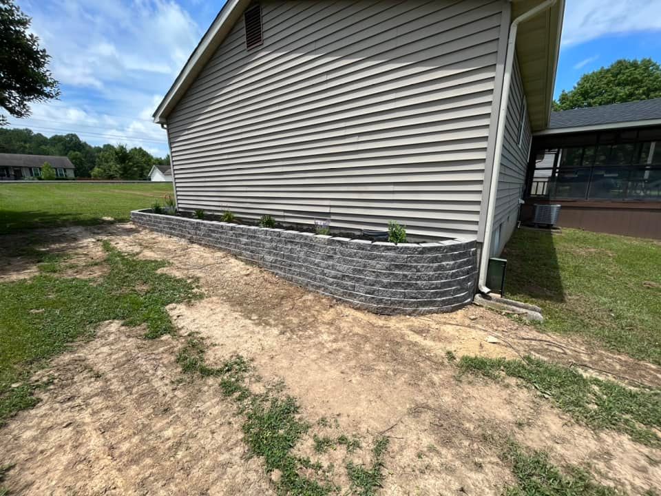 Our retaining wall construction service enhances your landscape's functionality and aesthetics, providing stability to sloped areas while preventing soil erosion, ensuring a durable and visually appealing solution for your property's needs. for Taylormade Land Service LLC in Hopkins County, KY