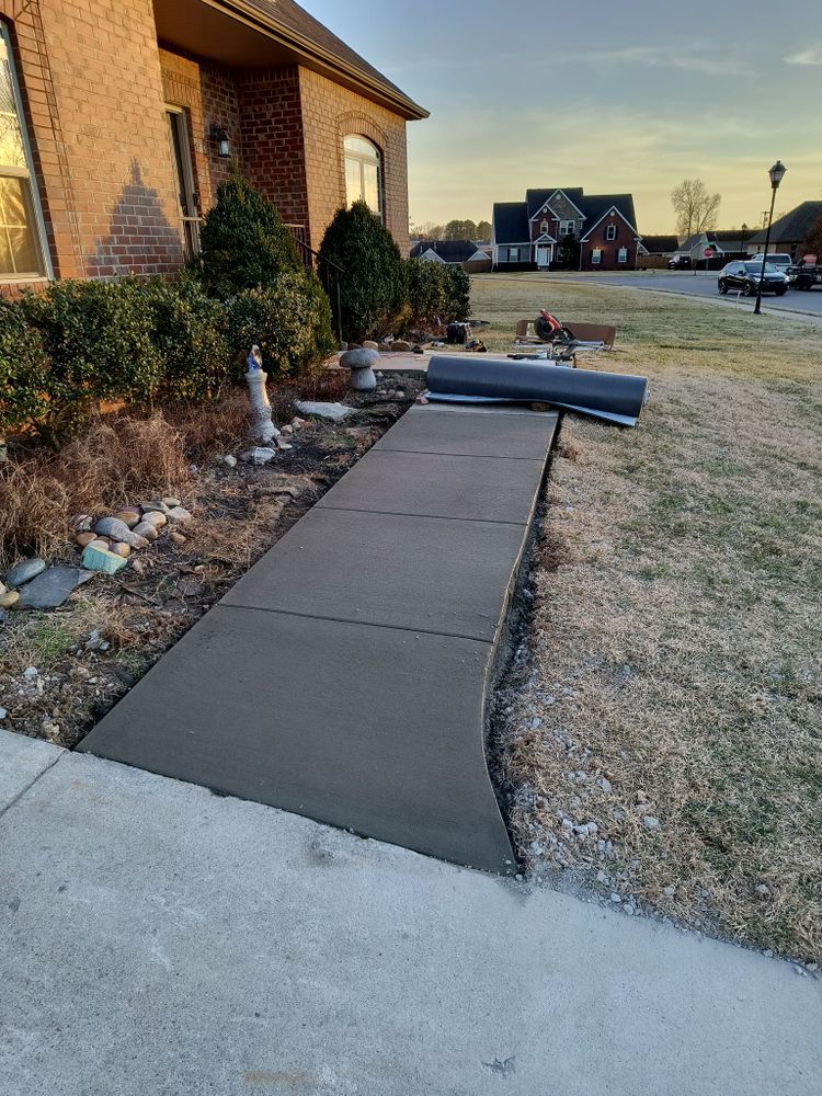 Our Sidewalk Installation service provides durable, attractive pathways that enhance your home's curb appeal. We use high-quality concrete and expert craftsmanship to ensure long-lasting, safe, and aesthetically pleasing sidewalks for your property. for Layne It Down Concrete Artisan in Hopkinsville, KY