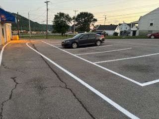 Enhance your home's curb appeal and safety with our professional line striping service. Precisely marked driveways and parking areas ensure clear navigation, increase property value, and promote a tidy appearance. for Bryant Property Solutions in Altoona, PA