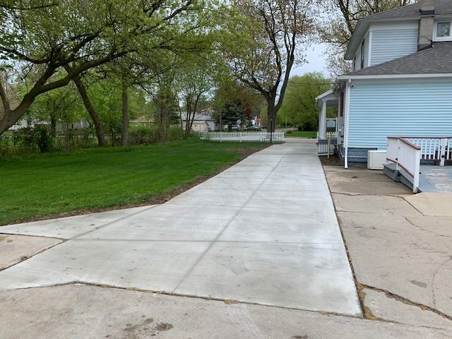 Transform your outdoor space with our Sidewalk Installation service. Our experienced team will install high-quality concrete sidewalks to enhance the curb appeal and functionality of your home. for Martin Concrete Contracting in Lexington, MI