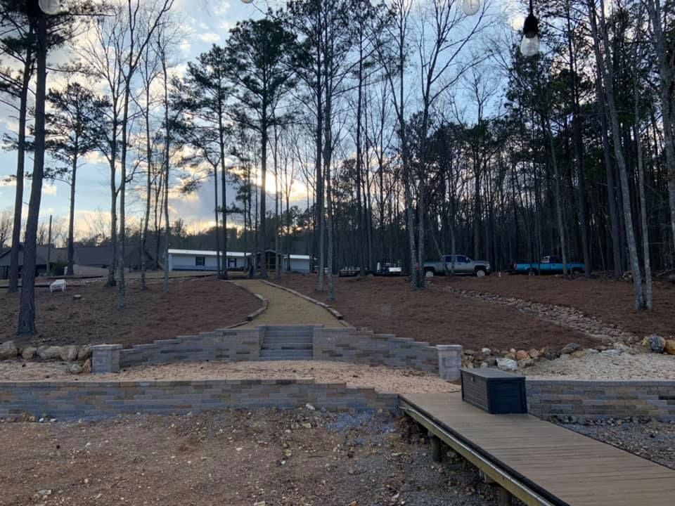 Our Retaining Walls service offers homeowners a reliable and aesthetically pleasing solution to prevent soil erosion, create multi-level landscaping, and enhance the overall appearance of their outdoor spaces. for Greenwood Lawn & Landscaping LLC in Talladega, Alabama