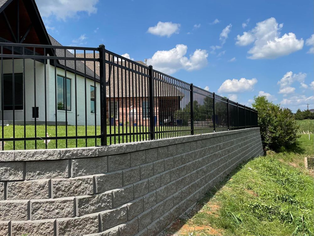 Our Retaining Wall Construction service provides expert design and installation of durable retaining walls to enhance the beauty and functionality of your landscape, ensuring stability for years to come. for Stallion Design And Construction in Norman, OK