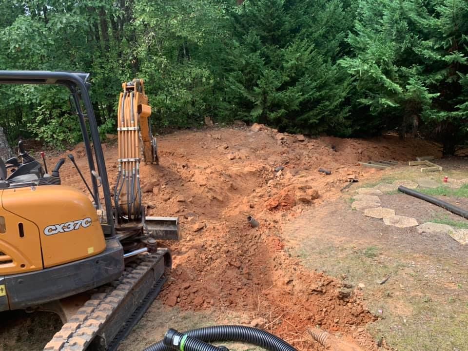 Our Foundation Digging service provides precise, reliable excavations to create a solid base for your construction projects, ensuring stability and strength. Our experienced team delivers efficient work tailored to meet your specific needs. for Under Grace Transport and Grading in Marble Hill, GA