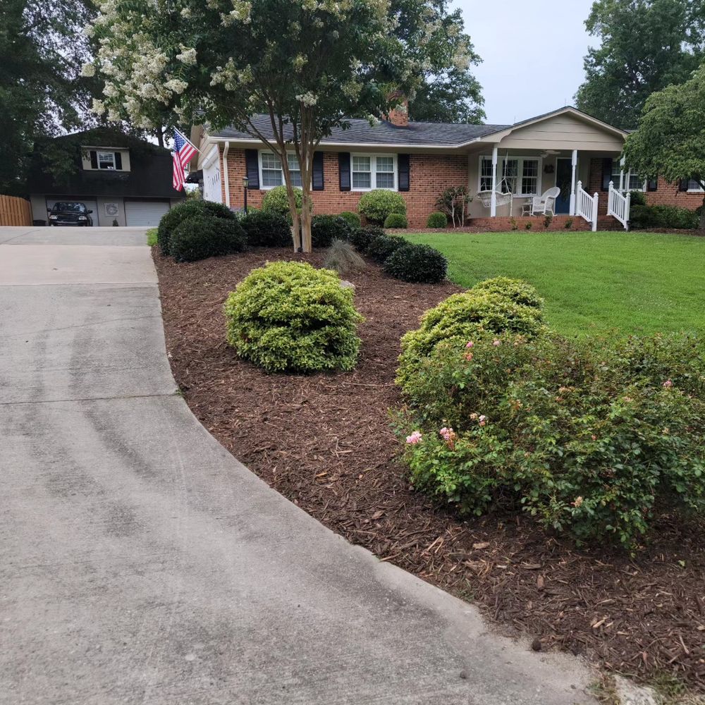 Our Mulch Installation service offers homeowners a convenient way to enhance the aesthetics of their lawn while protecting plants by providing a layer of organic material. for Piedmont Lawn and Landscaping in Lexington, NC