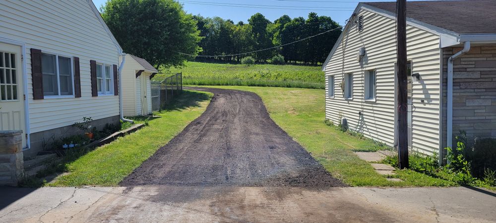 Enhance your home's curb appeal with our professional driveway and sidewalk installation services, featuring durable stone veneer installation for a sophisticated look that complements any landscape design. for Admiring Landscapes in Lancaster, OH