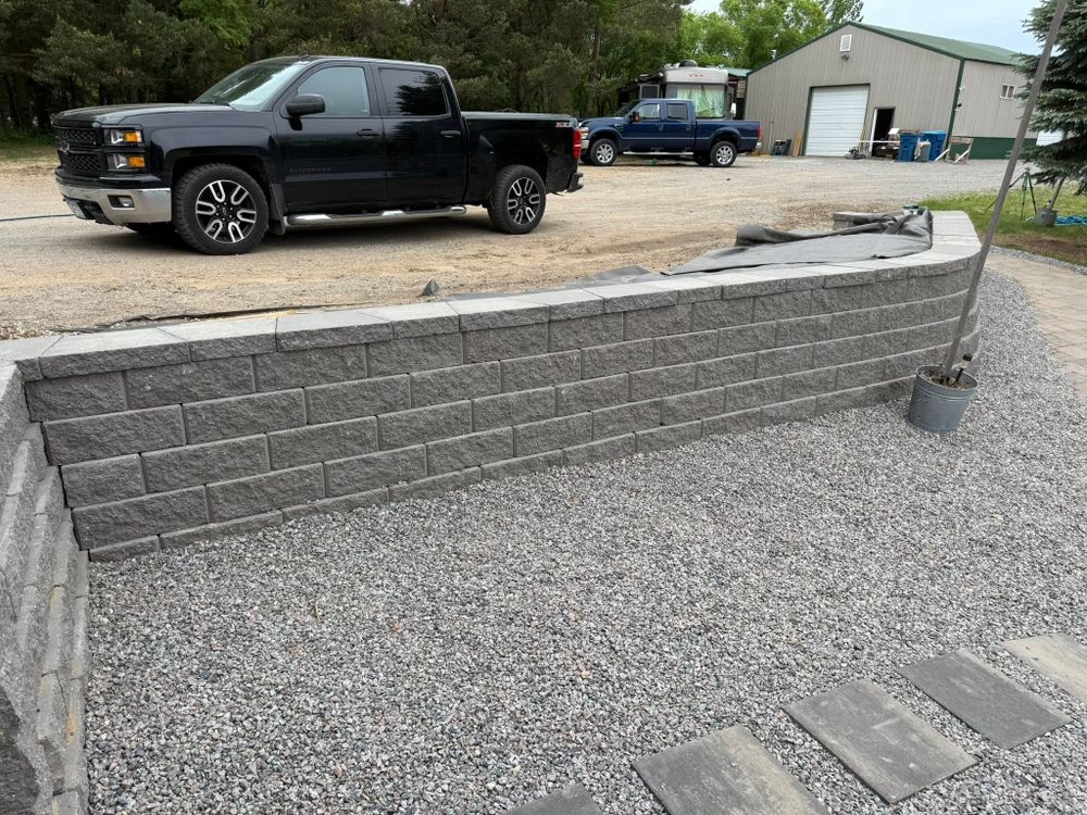 Our Retaining Wall Construction service expertly stabilizes soil, prevents erosion, and enhances landscape aesthetics. We ensure durable structures tailored to your property's unique needs with professional craftsmanship and attention to detail. for J’s Snow and Landscape in Oak Park, MN