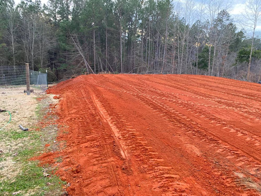 Our mulching service helps protect your property by clearing out excessive brush and vegetation while also enriching the soil with organic matter, promoting healthy plant growth and preventing weed infiltration. for H&H Dirt Work in Corinth, MS