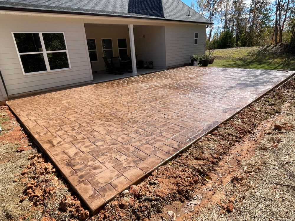 Our professional Stamped Concrete Installation service offers homeowners a durable and customizable option for enhancing the aesthetics of their outdoor spaces with beautiful patterns and textures. for Compadres Concrete in Griffin, GA