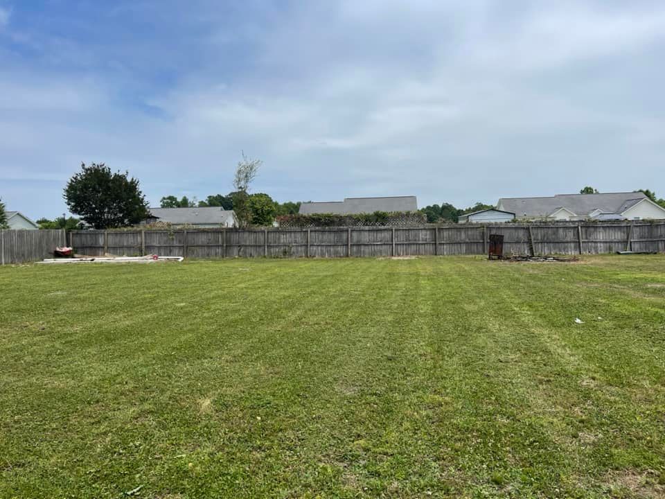 Our Lawn Maintenance service ensures a lush, healthy lawn through regular mowing, precise edging, fertilization, and weed control. Trust us to keep your outdoor space immaculate and thriving all season long. for Voilà Magic LawnCare Services in Jacksonville, NC