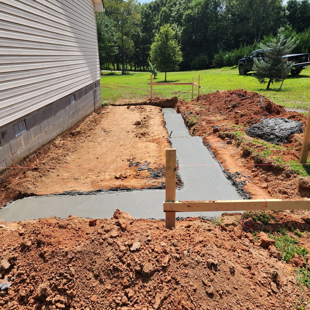 Our expert team offers professional concrete footings service for houses, ensuring a solid foundation that provides stability and longevity to your home. Trust us for reliable land preparation services. for Parker's Grading Services in Cleveland, GA