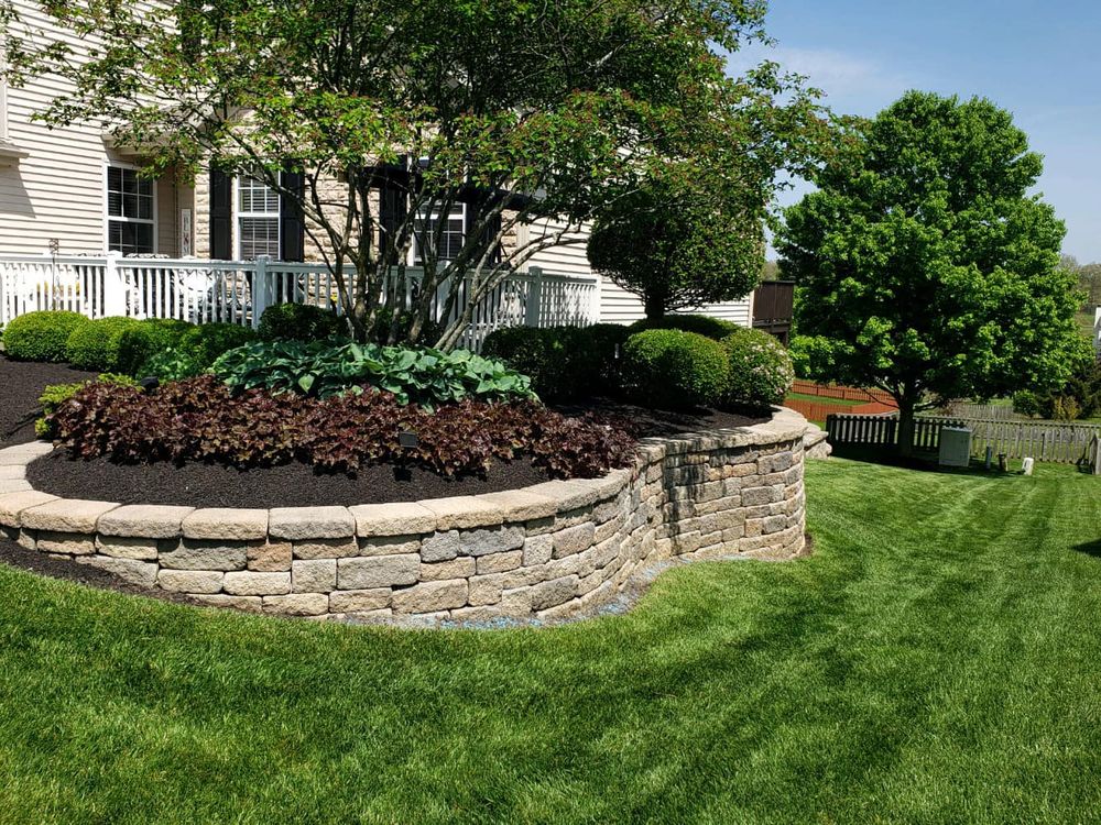 Our retaining wall construction service provides expert design and installation to prevent soil erosion, improve drainage, and create functional outdoor spaces that enhance the beauty and value of your property. for Dewhurst Landscaping & Lawncare in Pickerington, OH