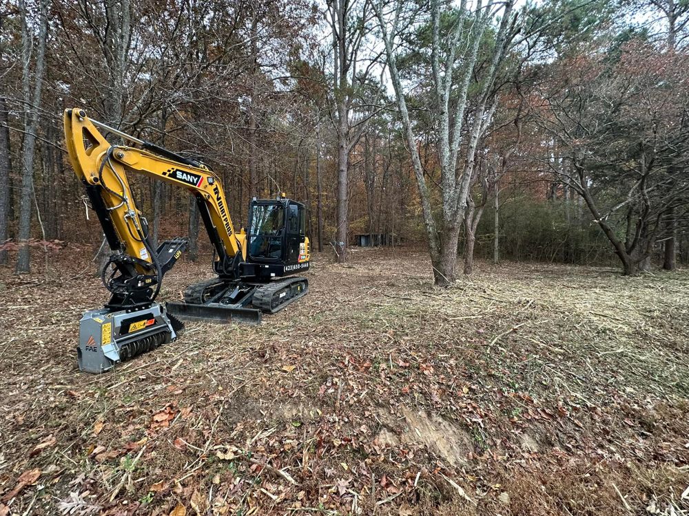 Our Forestry Mulching service efficiently clears land by converting unwanted vegetation into beneficial ground cover, reducing erosion and promoting soil health through natural mulch installation for an eco-friendly landscape solution. for TN DIRT PROS in Cleveland, TN