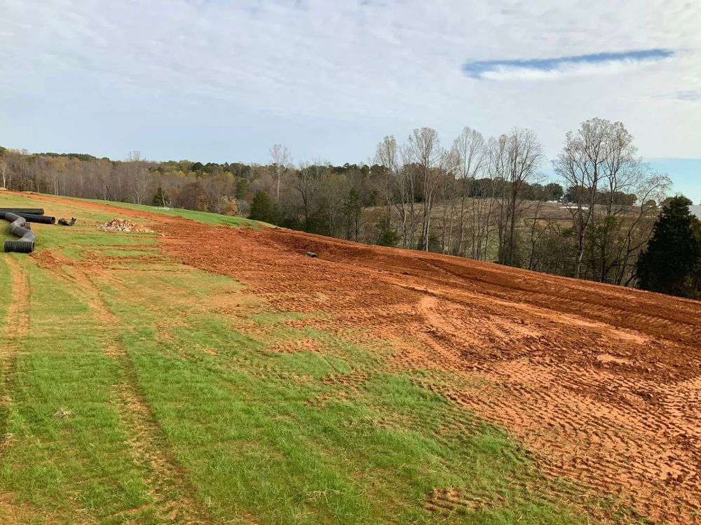 Enhance your property's drainage and curb appeal with our expert grading services. We skillfully level your land, ensuring effective water runoff and a stable foundation for landscaping or construction projects. for Grading and Land Improvements in Mount Holly, NC