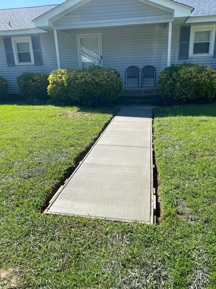 Our professional Sidewalk Installation service enhances your home's curb appeal with durable, custom-designed concrete pathways, ensuring safety and aesthetics while using high-quality materials for long-lasting results tailored to your needs. for Big League Concrete and Grading in Batesburg-Leesville, SC