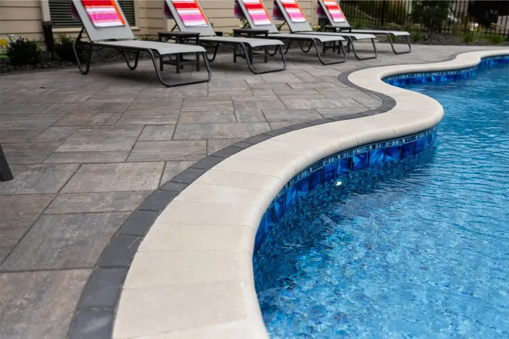 Enhance your pool's safety and aesthetics with our expert pool coping service, providing durable, stylish edges that seamlessly blend with your landscape for a polished, sophisticated look around the water's edge. for Black Diamond Custom Pools LLC in Azle, TX