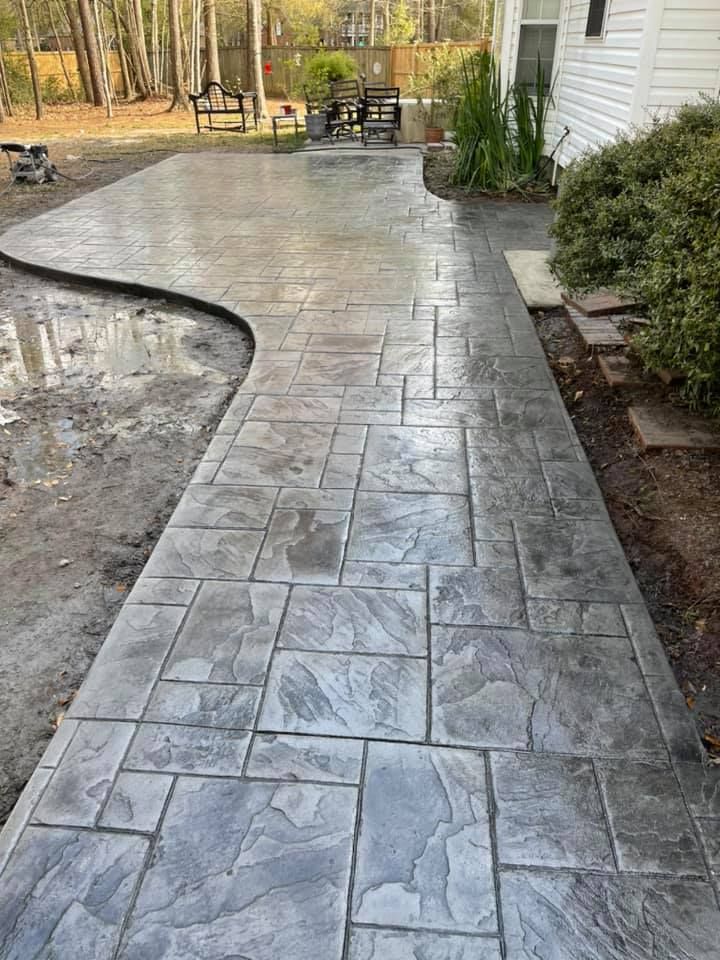 Enhance your home's appeal with our Stamped Concrete Installation, offering durable, customizable patterns and textures that mimic natural stones or bricks, promising both beauty and functionality for patios, driveways, and walkways. for Fichter Concrete in North Charleston, SC