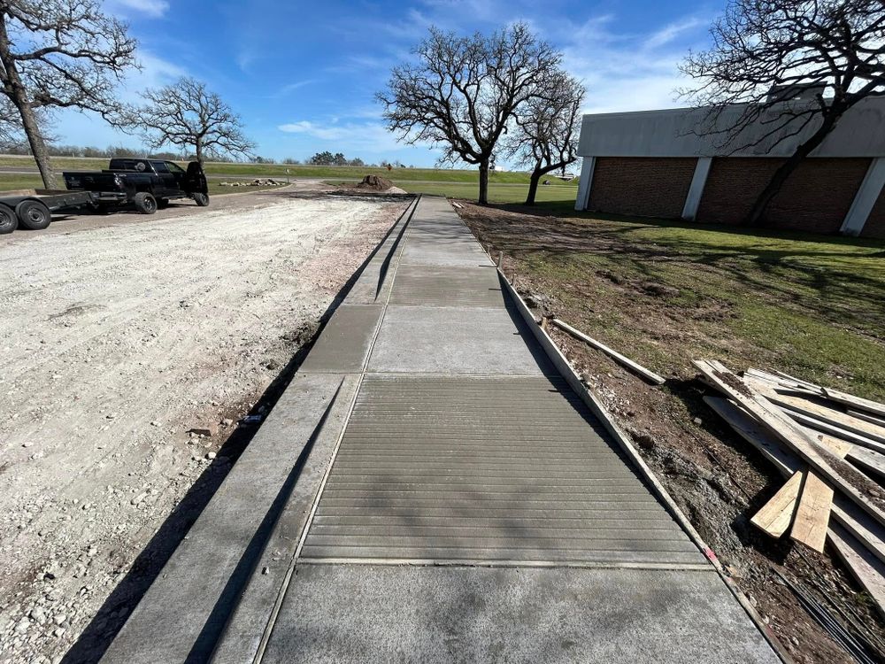 Enhance safety and visibility with our expert Commercial Sidewalks service, perfect for seamless integration under commercial parking lot lights, ensuring durable and attractive pathways designed specifically for your property's needs. for J & M Contracting in Hewitt, TX