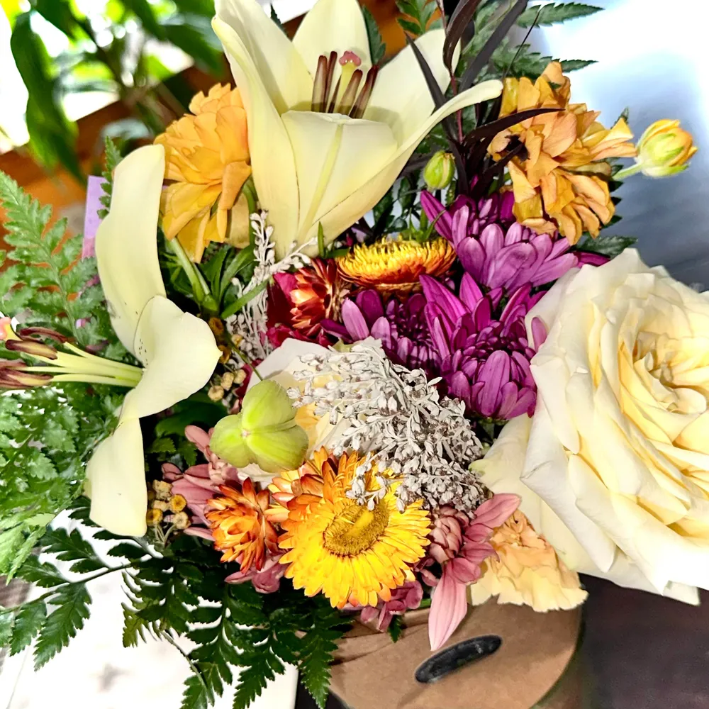We hand-tie this bouquet full of fresh flowers and present it in a paper wrap, so it can be placed in a vase as is, or untied and arranged as the recipient of your gift sees fit! Upgrade options include more flowers for a fuller and more lush design. for The Dailey Daisy in Hardwick, VT