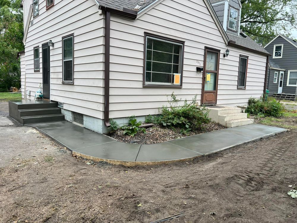 Enhance your home with our expert concrete sidewalk installation service, providing durable, aesthetically pleasing concrete walkways that increase safety and curb appeal while ensuring long-lasting performance to complement any residential landscape. for Divine Designs General Contracting LLC  in Minneapolis, MN