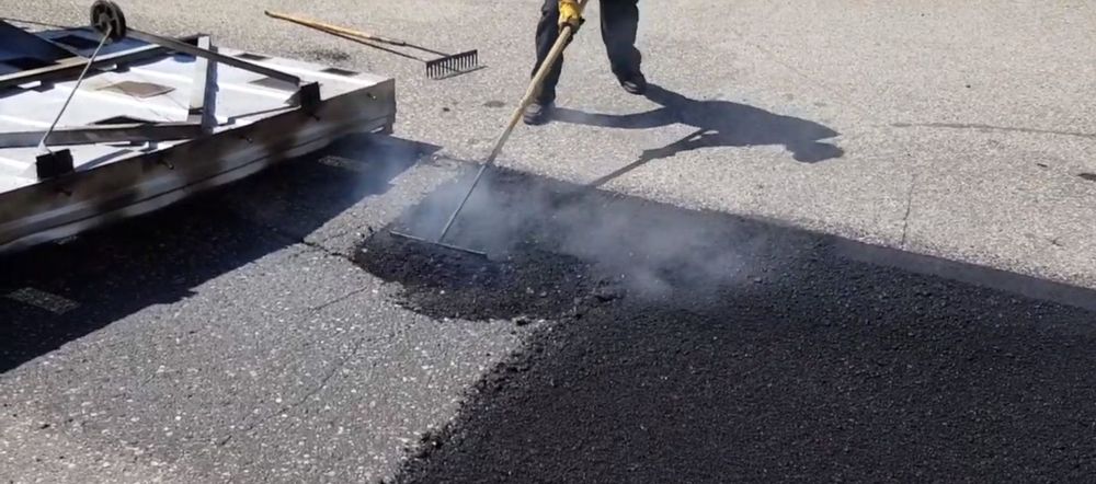 Our Asphalt Repair service revitalizes your driveway by fixing cracks, potholes, and surface damage efficiently and affordably, ensuring a smooth, durable finish that enhances curb appeal and extends the pavement's lifespan. for Blue Ridge Paving & Chip in Charlottesville, VA
