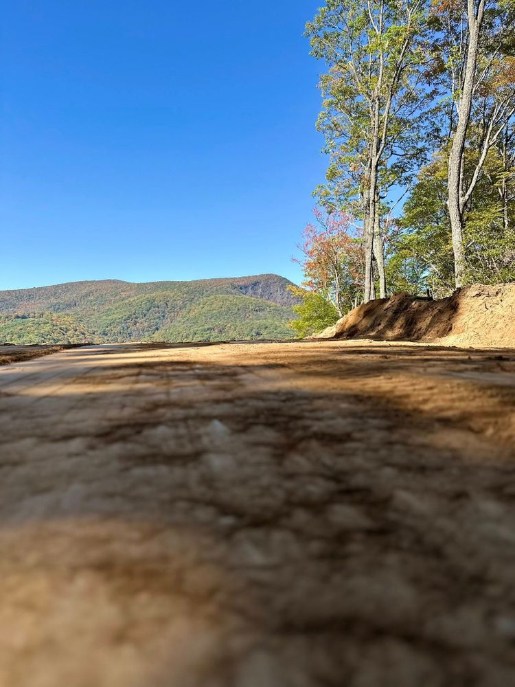 Our Grading and Leveling service ensures your land is expertly prepared, creating a stable foundation for construction projects with optimal drainage solutions to enhance safety and increase your property's longevity. for Trophy Ridge Grading & Hauling in Mountain City, TN