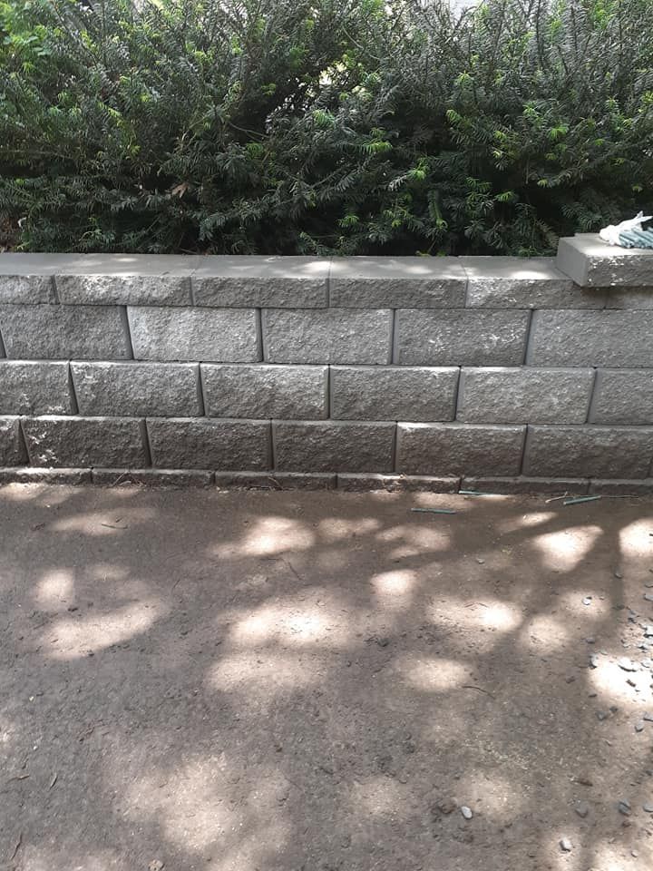 Our retaining wall construction service provides expertly designed and built structures to prevent soil erosion, create leveled areas for landscaping, enhance property aesthetics, ensuring long-term structural integrity for your home. for Oakhurst Landscaping and Tree Service in Charlotte, NC