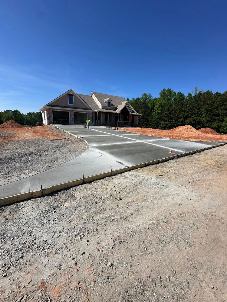 Enhance your home's curb appeal with our expert stamped concrete installation service, offering durable and stylish driveway solutions that combine functionality with aesthetic elegance, tailored to meet your unique design preferences. for J & Son Construction LLC in Forest City, NC