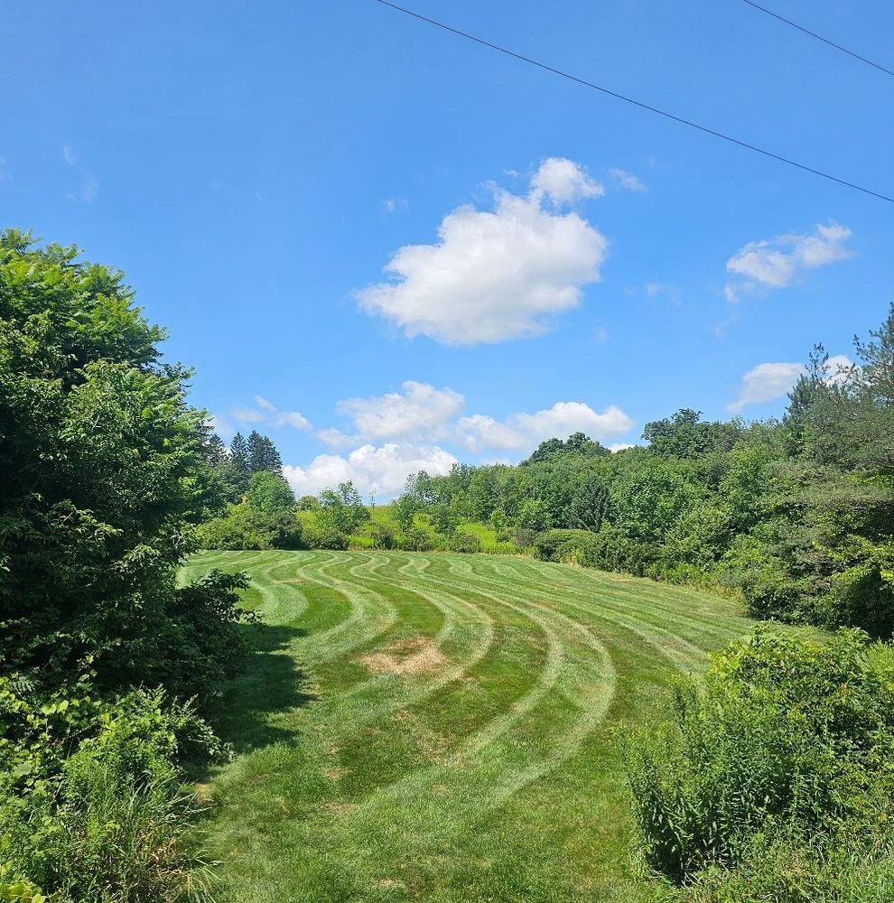 Our mowing service ensures a meticulously maintained lawn with precision cutting, edging, and trimming. Trust our professional team for a healthy, lush landscape that enhances your home's curb appeal effortlessly. for Summit Landscape & Const in Ithaca, NY