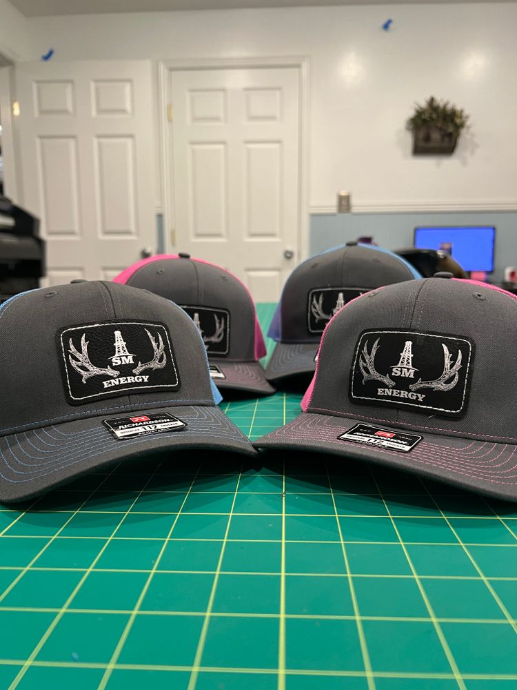 Our Leather Patch Hats service creates durable, stylish custom hats featuring expertly crafted leather patches, giving homeowners a unique way to showcase personality, promote their brand, or commemorate special projects. for Infinity Custom Design in Roosevelt, UT