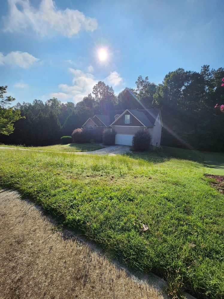 Our Bush Hogging service efficiently clears overgrown brush and vegetation from your property, creating a clean and well-maintained outdoor space that enhances the aesthetics of your home. for Deeply Rooted Lawn Installations - Sod Installation & Hydroseeding Services in Winder, GA