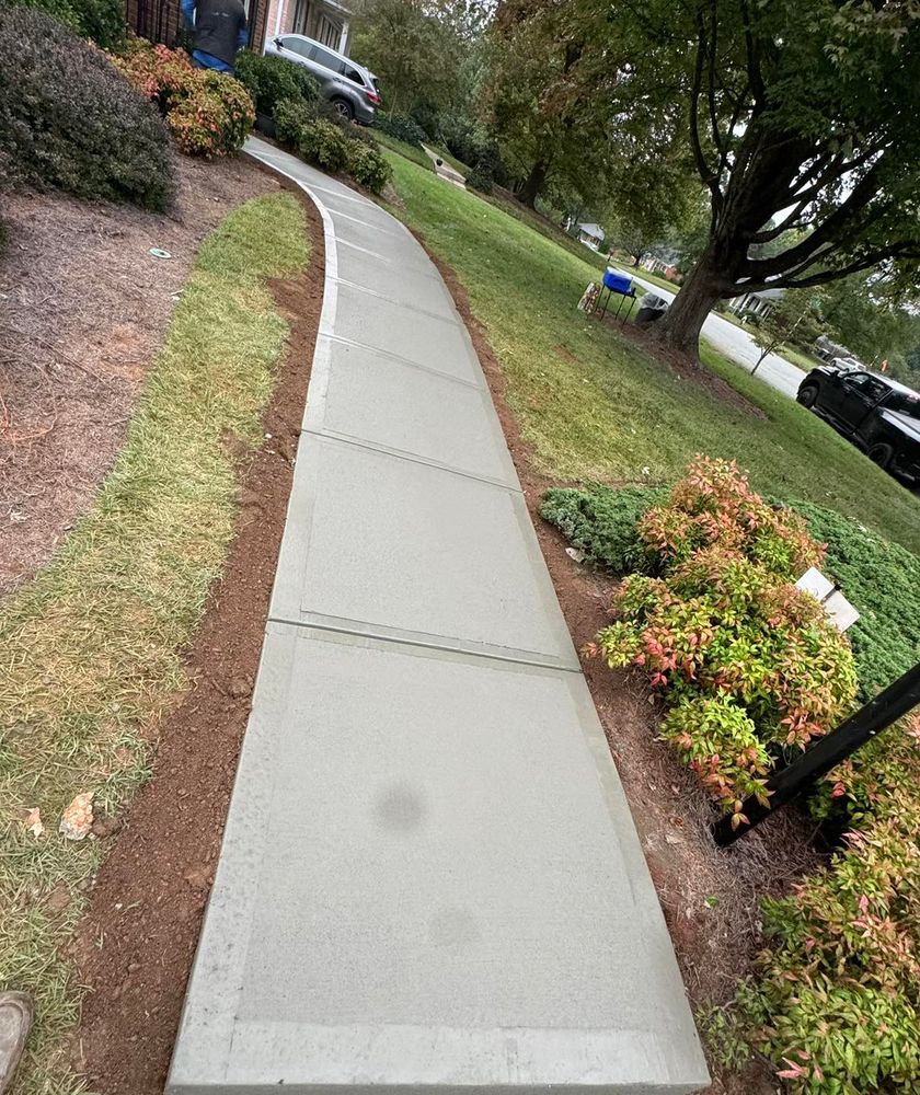 Transform your outdoor space with our Sidewalk Installation service, offering durable, high-quality concrete pathways that enhance curb appeal and ensure safe pedestrian access for your home environment. for Rivera Concrete INC. in Greensboro, NC