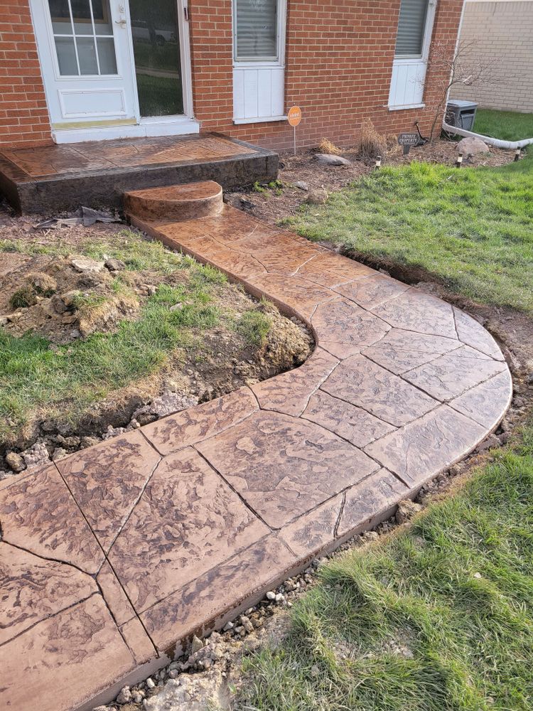 Our Sidewalk Installation service provides durable, aesthetically pleasing walkways that enhance your home's curb appeal. Our expert team ensures precision and quality from design to completion, prioritizing safety and functionality for lasting results. for Bear Concrete & Outdoor Services in Auburn Hills, MI