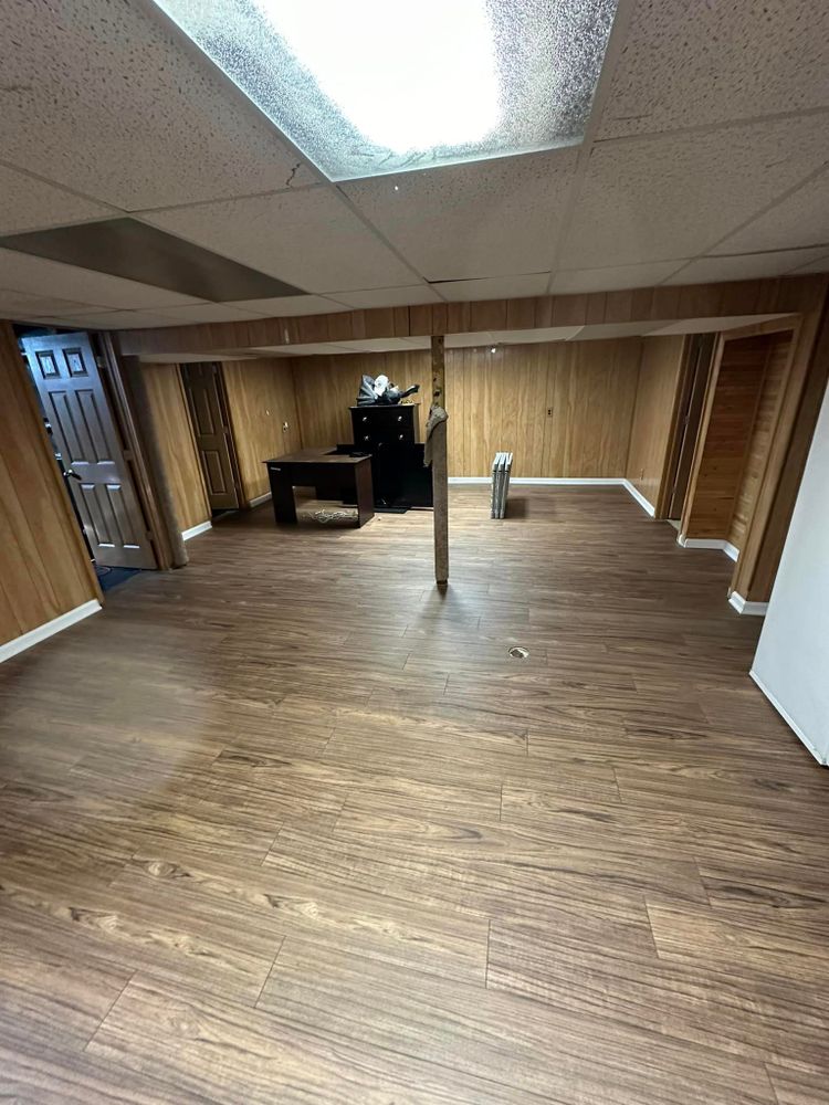 Our Glue Down Flooring (LVT) service offers durable and easy-to-maintain flooring that mimics the look of laminate. Trust our experienced team to expertly install this affordable and stylish option in your home. for Reyna’s Flooring & Trim Carpentry  in Allen PArk, MI