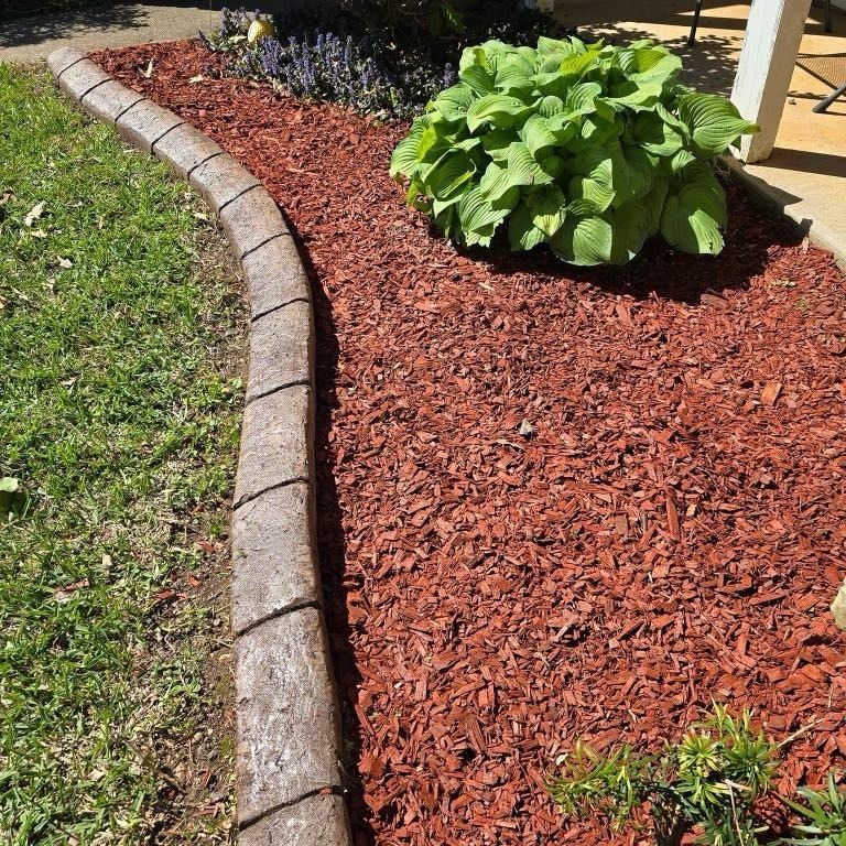 Enhance your garden's health with our mulching service using a specialized mulching mower, which recycles grass clippings into natural fertilizer, promoting nutrient-rich soil and reducing the need for chemical treatments. for Artistic Edges LLC in Texarkana, AR