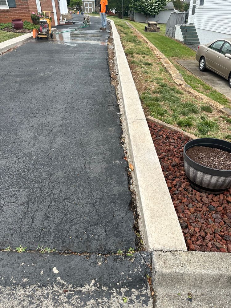 Our Seal Coating service enhances your driveway's durability and appearance, protecting it from weather damage, cracks, and fading while extending its lifespan with a smooth, sleek finish. for Adkins Solutions LLC in Bedford County, VA