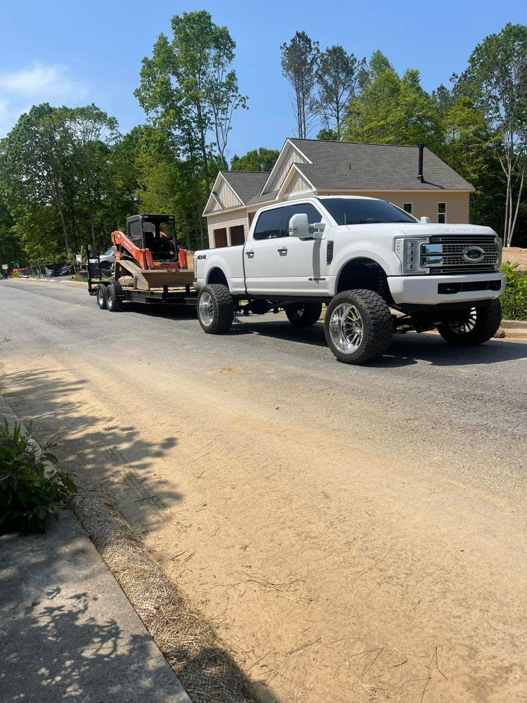 Our hauling service provides efficient and reliable transportation of debris, soil, and construction materials, ensuring your property remains clean and organized throughout any excavation or landscaping project. for Cline's Land Management in Dalton, GA