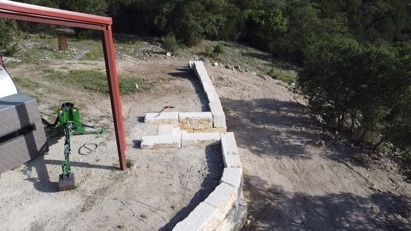 Limestone blocks retaining wall  for De Leon Carpentry & Renovation  in Leakey, TX