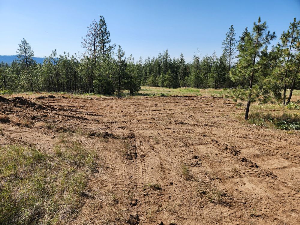 Our Land Grading service ensures your property has a smooth, level surface for optimal drainage and foundation stability, enhancing landscaping visuals and preventing erosion or water issues effectively. for Model A Excavating in Spokane Valley, WA