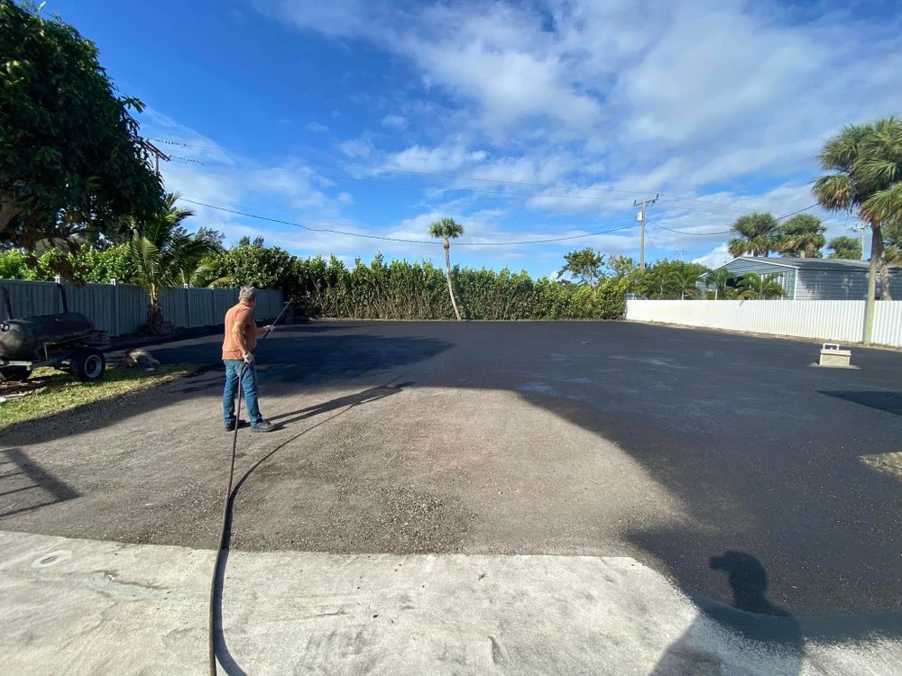 Enhance your driveway's durability and appearance with our professional seal coating service, protecting against weather damage and wear while extending the lifespan of your asphalt surface for years to come. for PavePros in West Palm Beach, FL