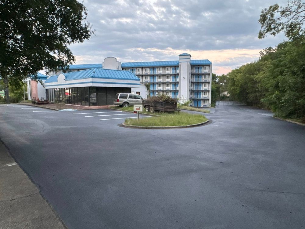 Sealcoating protects your asphalt driveway from sun, water, oil, and cracks while restoring a rich black finish. It extends pavement life, improves curb appeal, and helps prevent costly repairs. for JBS Paving in Cedartown, GA