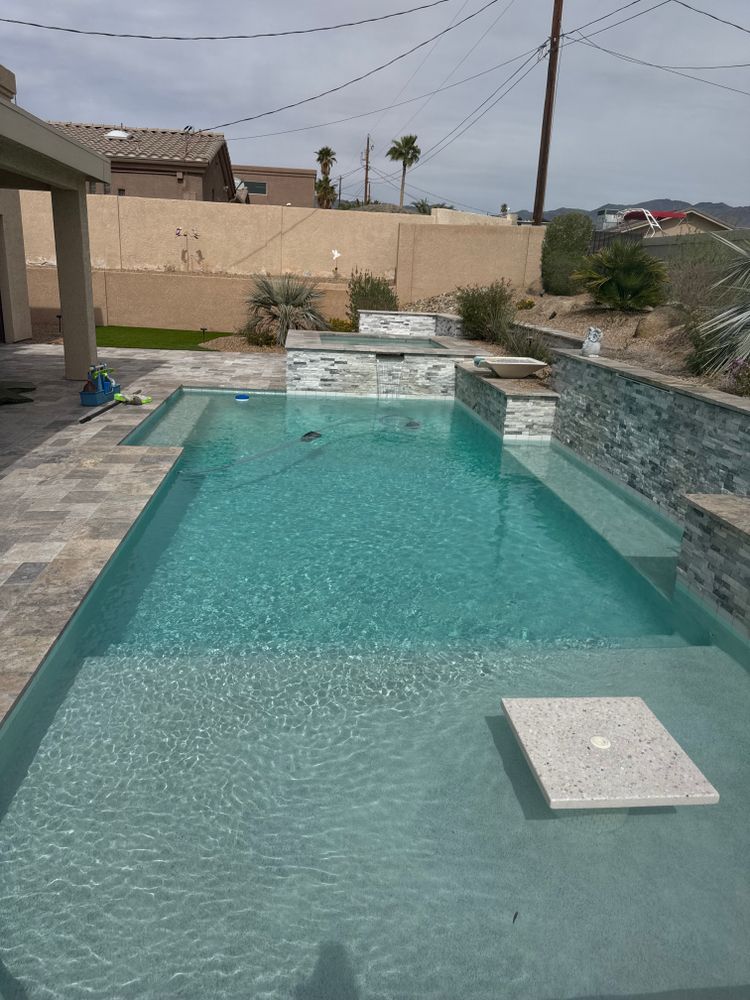 Our Chemical Treatment service ensures your pool stays clean and safe by balancing water chemistry, preventing algae growth, and eliminating harmful bacteria for a crystal-clear swimming experience all year round. for Clean Kort Pools in Lake Havasu City, AZ