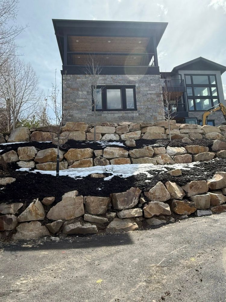 Our Retaining Wall Construction service enhances your landscape's stability and aesthetics with expertly designed walls that prevent soil erosion while seamlessly integrating with your property's design and ensuring long-lasting durability. for High Mountain Construction, INC in Peoa, UT